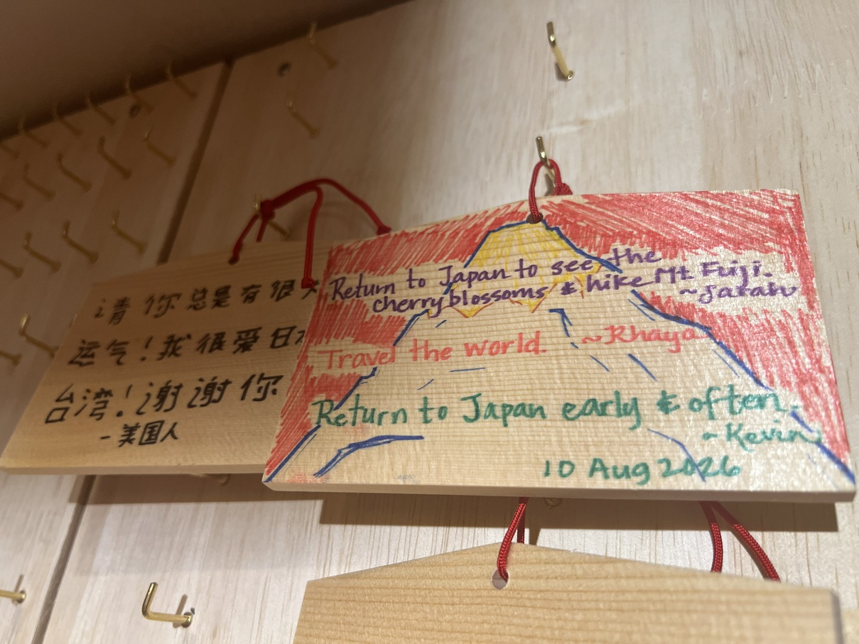 Tablillas ema con deseos escritos por miembros del fan club GYOPAO, expuestas en el restaurante
